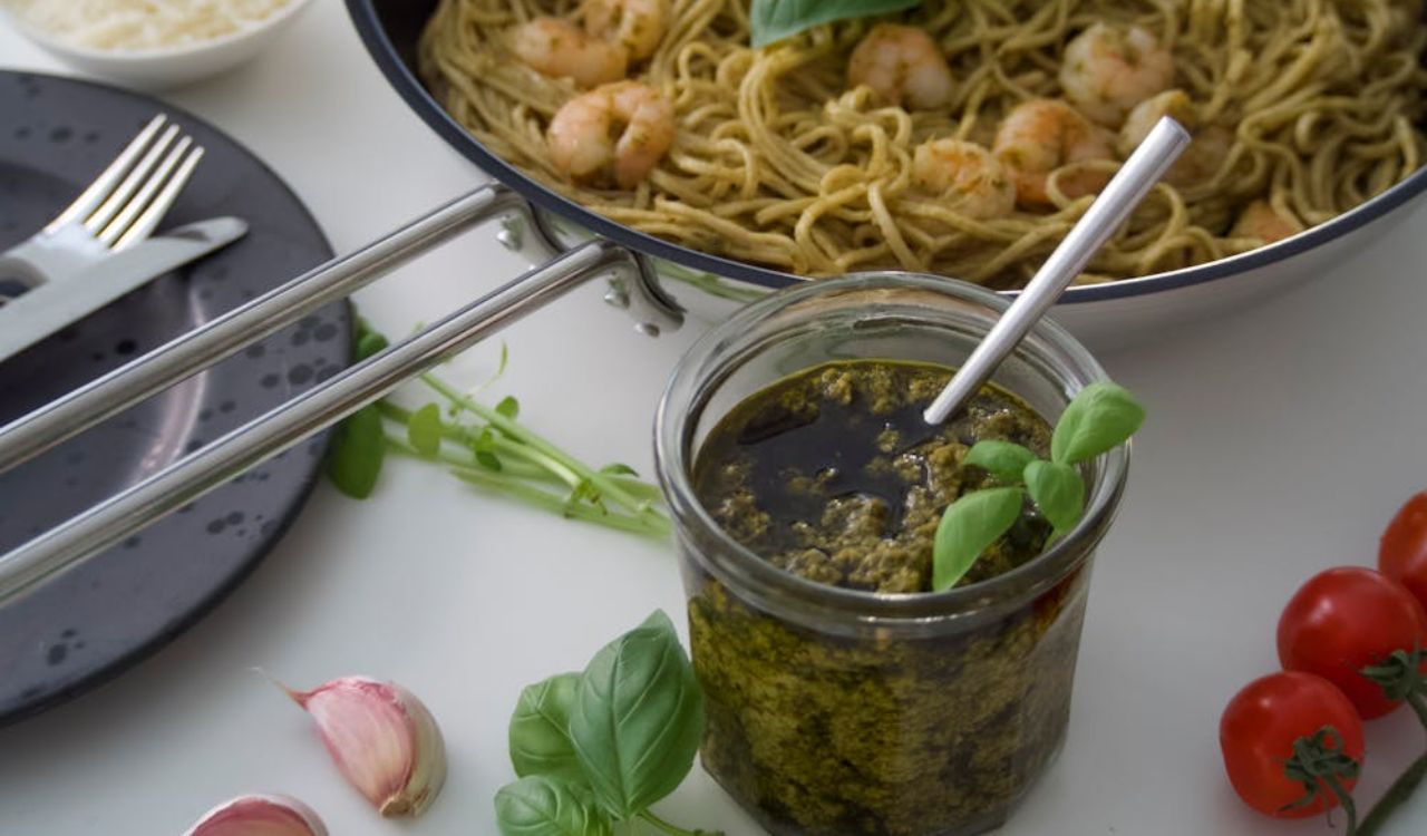 Pesto sauce in jar and pesto pasta