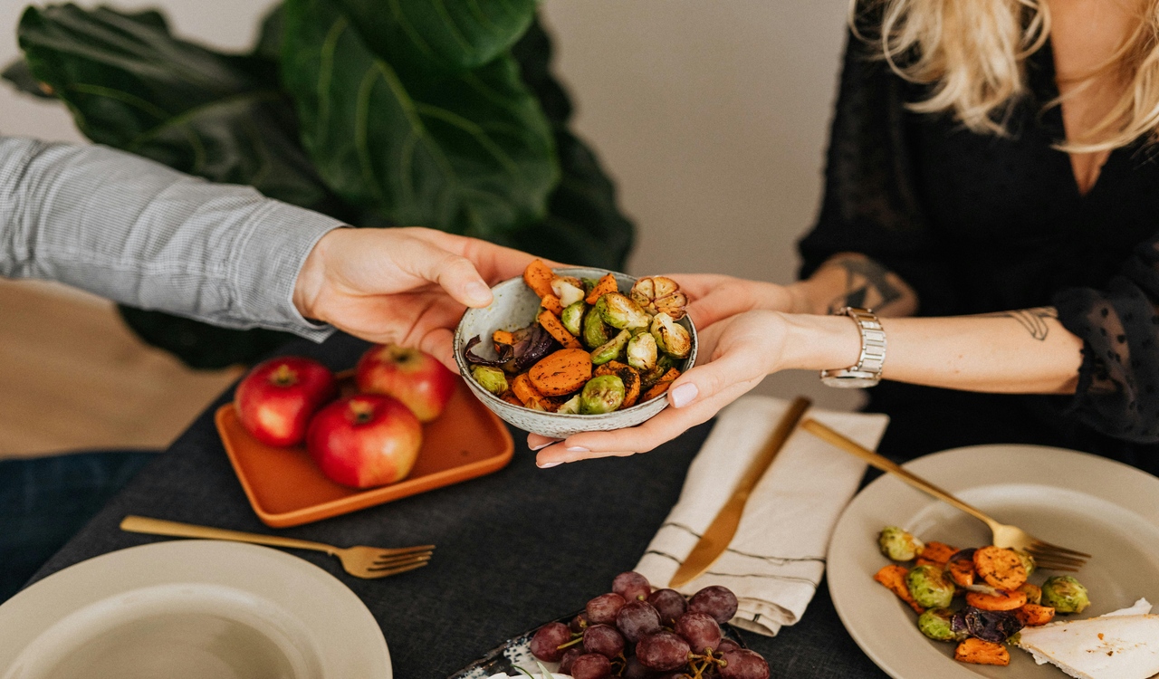 Woman Serving Food to her Husband at Dinner