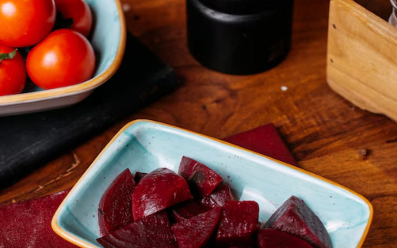 Small dish of pickled beet chunks on a wooden table