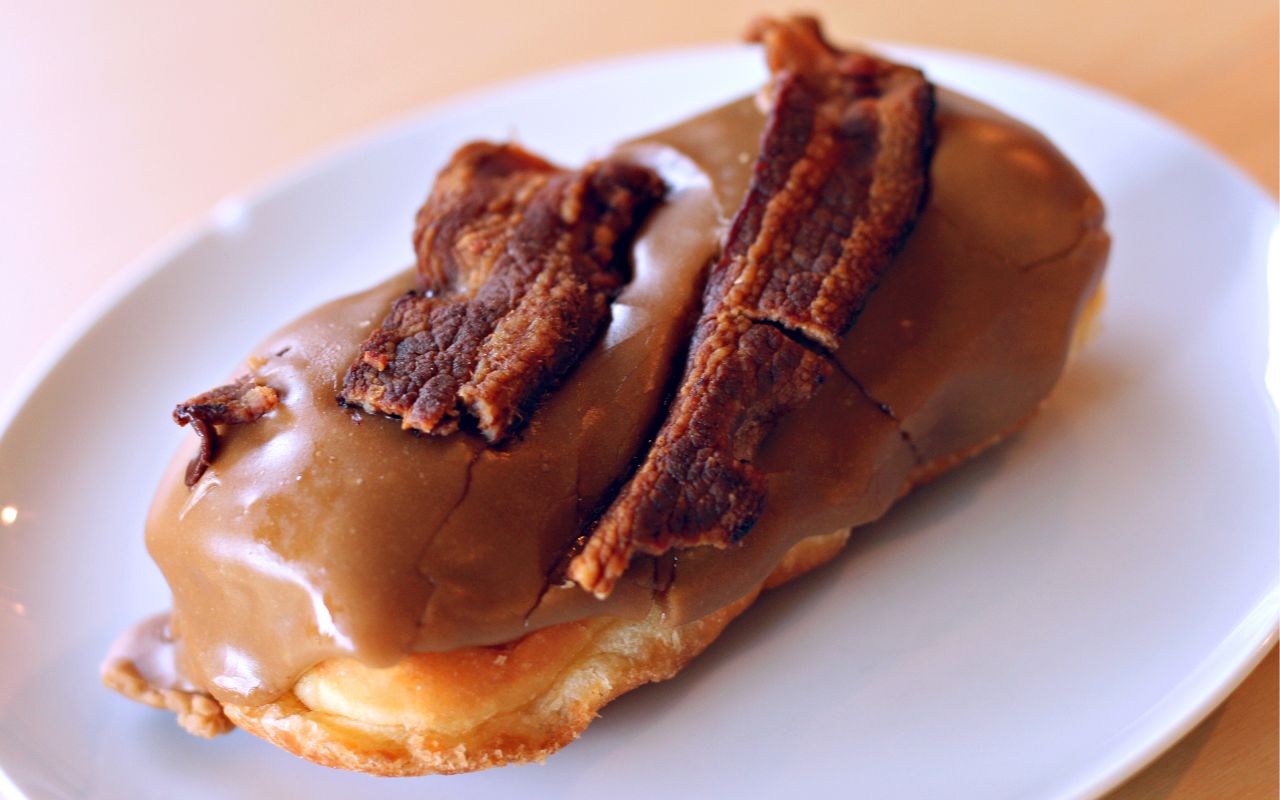 Maple bacon bar doughnut on a white plate