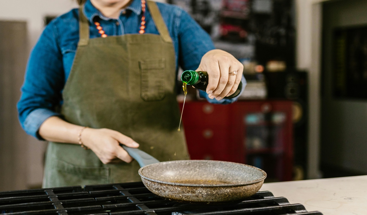 Chef Pouring Olive Oil into Frying Pan
