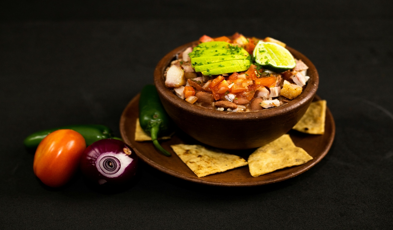 Dipping Sauce With Sliced Vegetables and Herbs and Nachos