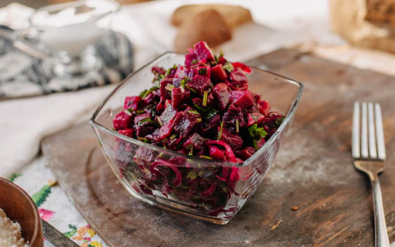 Glass bowl of shredded beet and apple slaw