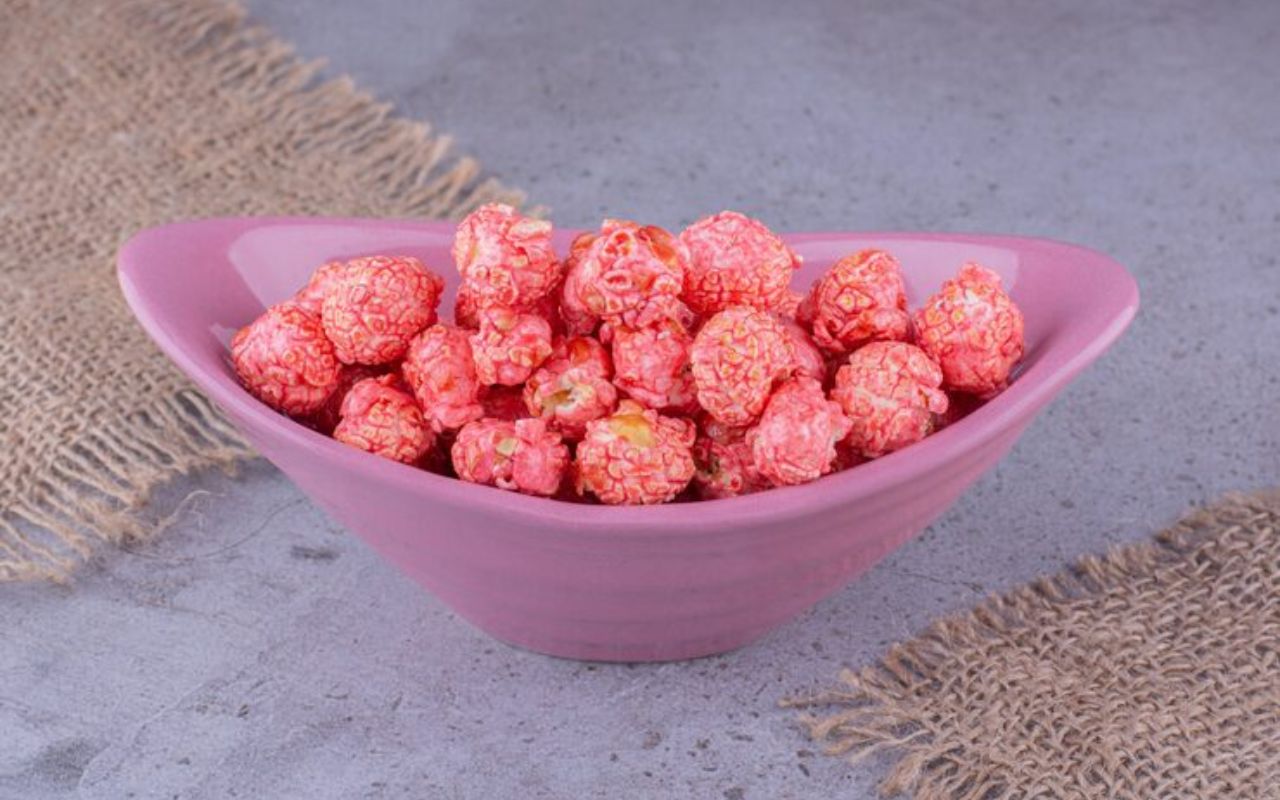 Pink candy-coated popcorn in a pink bowl