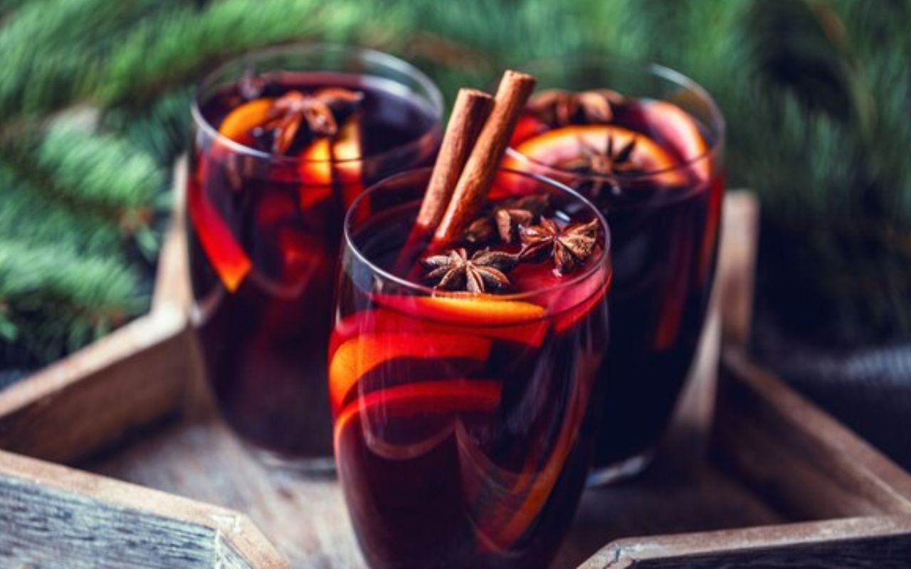 Spiced mulled wine with cinnamon sticks, star anise, and orange slices