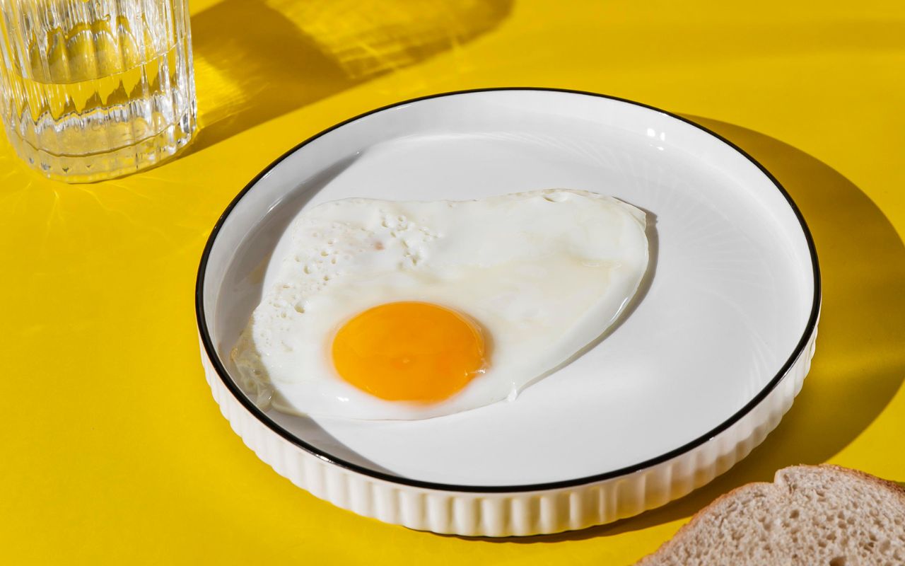Sunny-side-up egg on white plate