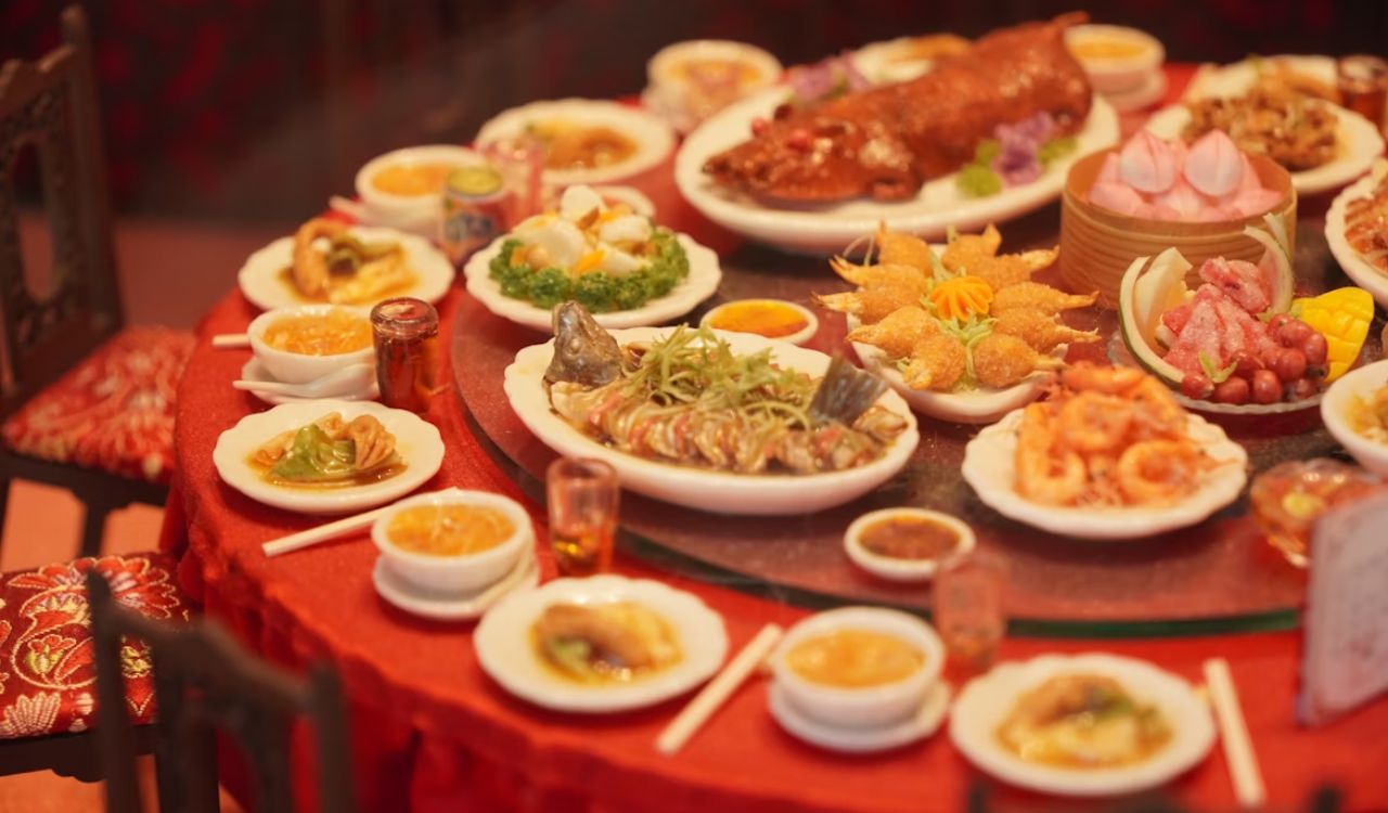Table laden with diverse Asian dishes