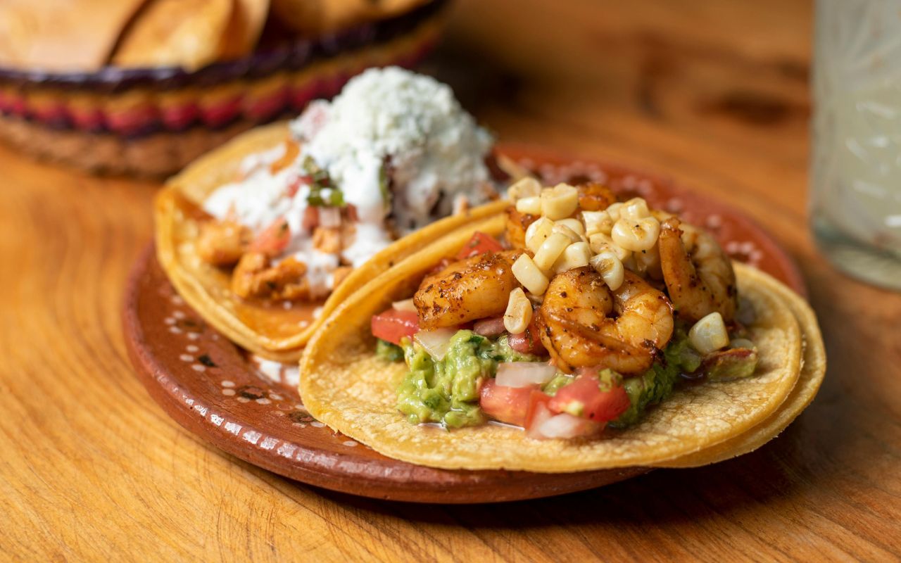 Shrimp tacos with guacamole and corn
