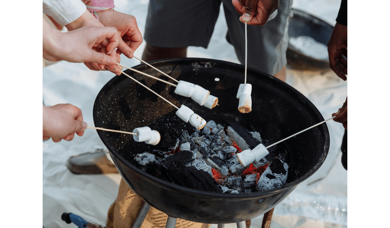 A Group of People Roasting Marshmallows on a Barbecue Grille