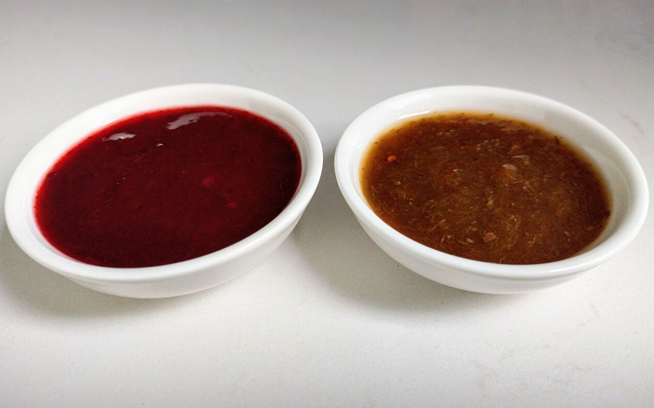 Two bowls of Tkemali sauce, one red and one brown