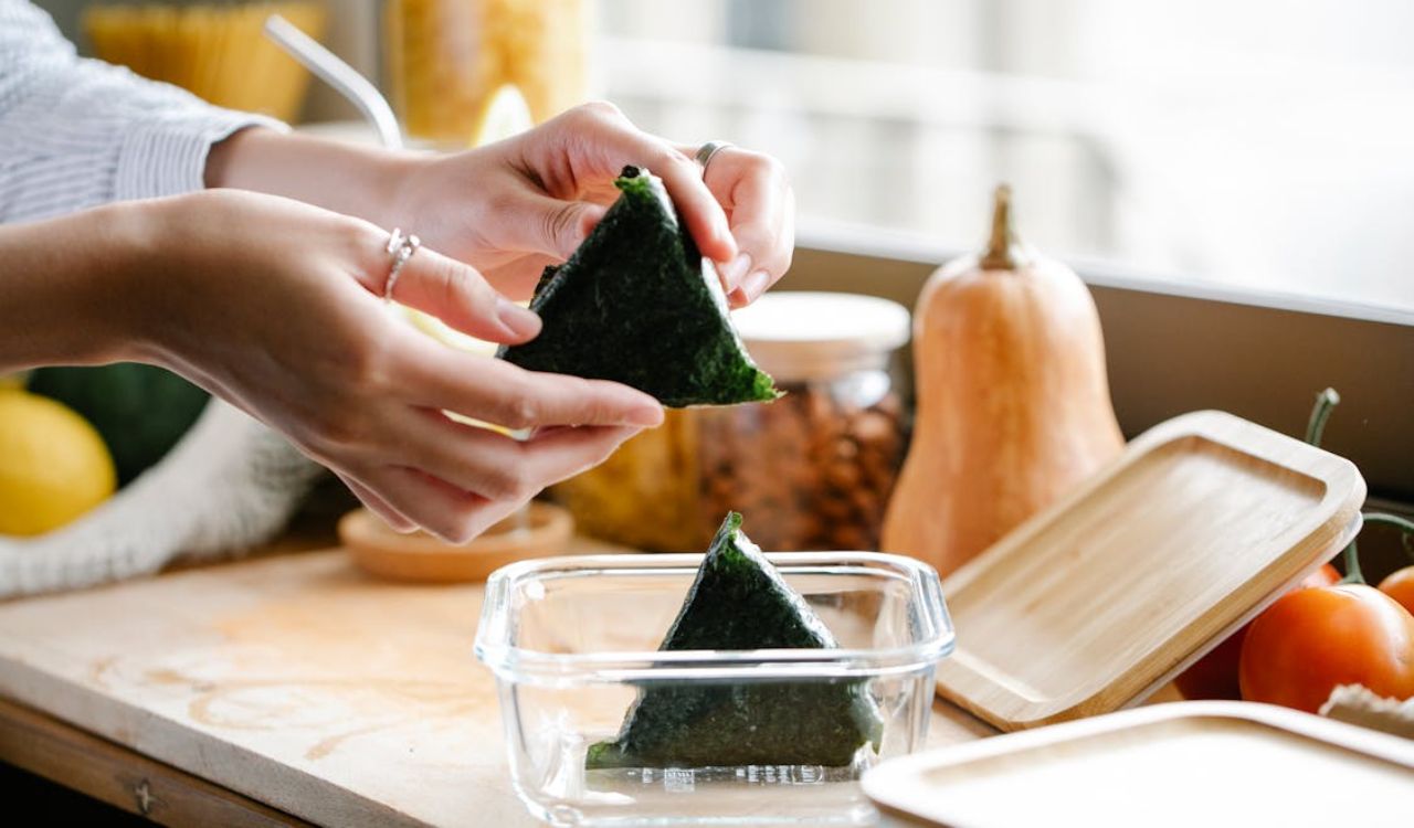 Woman with onigiri at kitchen counter