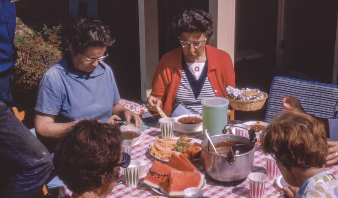 Women sitting beside table