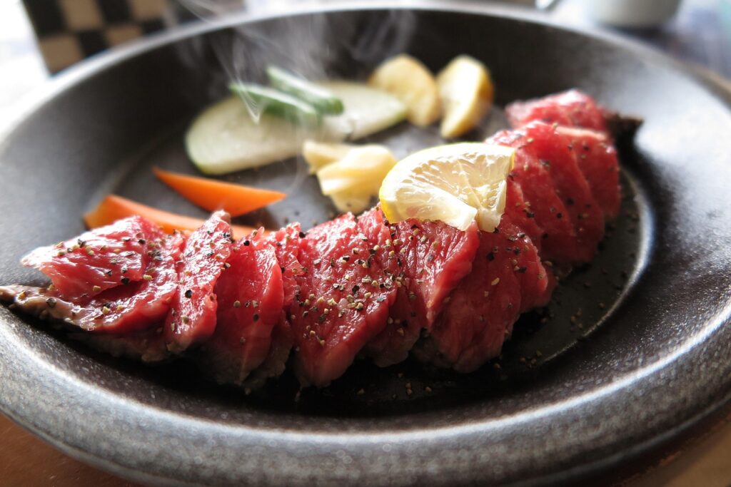 Sizzling steak on a hot plate.