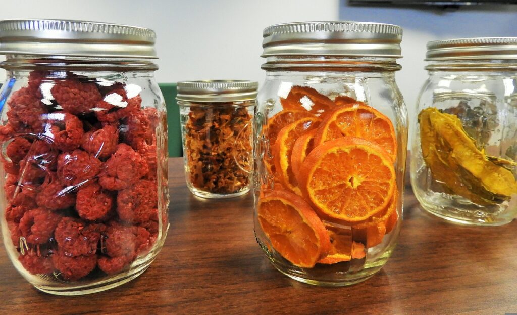 Pantry shelf lined with jars of freeze-dried snacks.