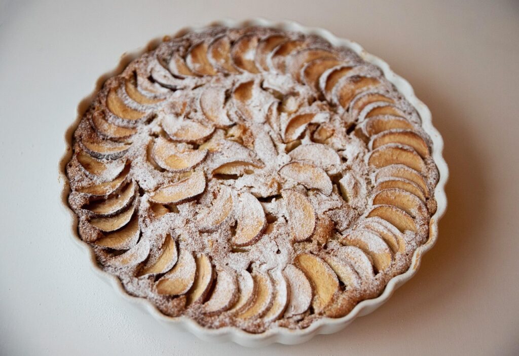 Classic American apple pie slice on a plate with a beaten crust.