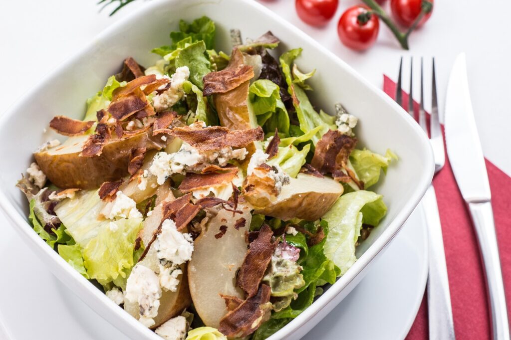 Salad topped with grilled chicken or roasted chickpeas.