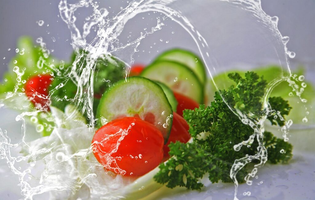 Close-up of assorted fresh greens in a salad spinner.