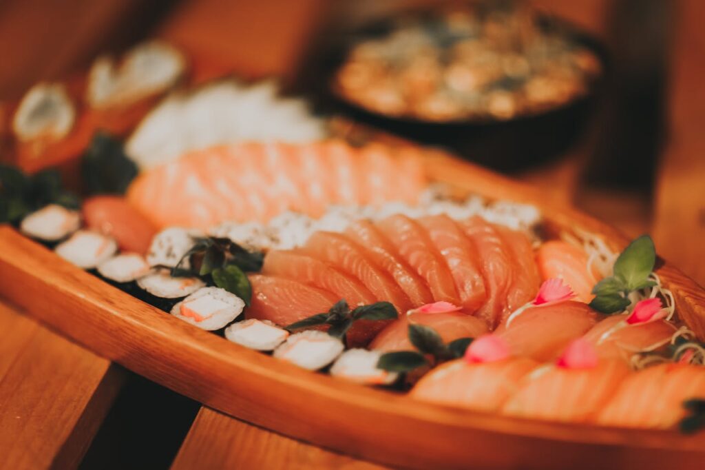 Elegant sashimi plate with slices of tuna and salmon arranged with daikon garnish.