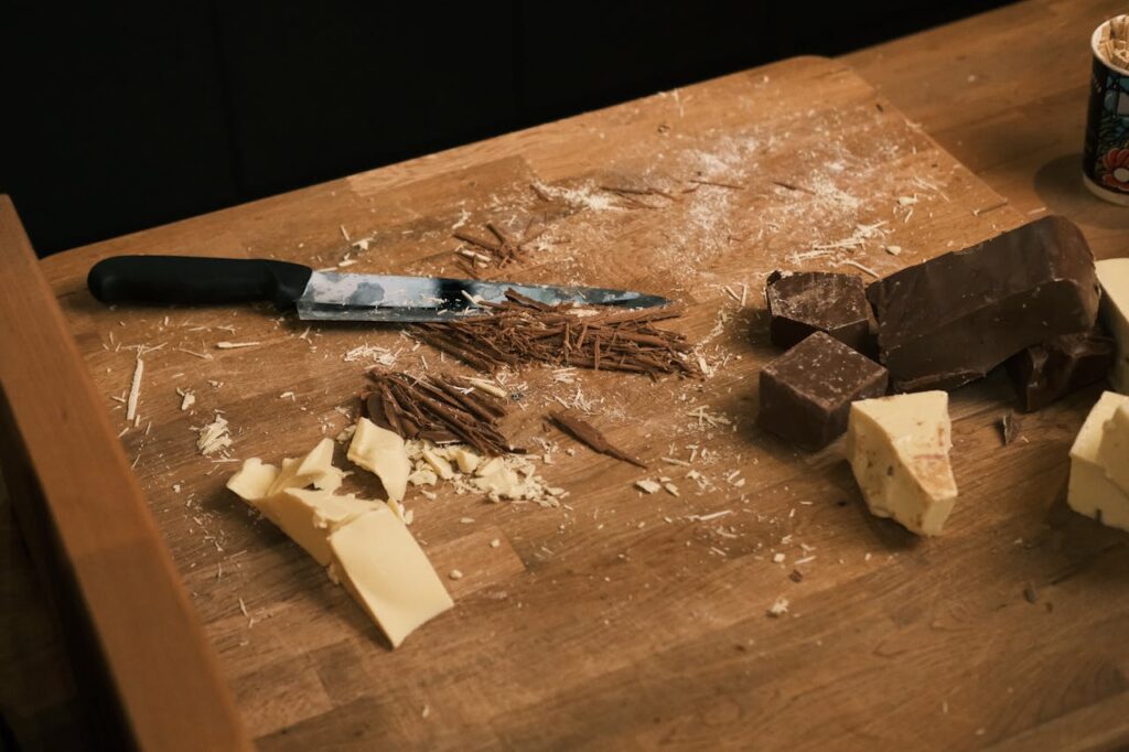 Chocolate Blocks and Shavings on Wooden Board