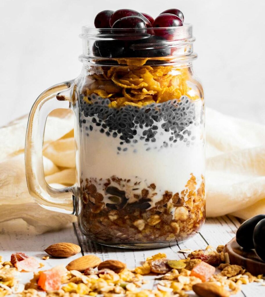 Yogurt parfait layered with granola bar crumbles and fresh berries.