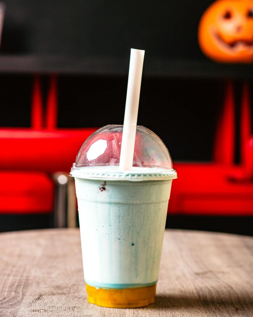 Colorful Frozen Beverage in Plastic Cup on Table