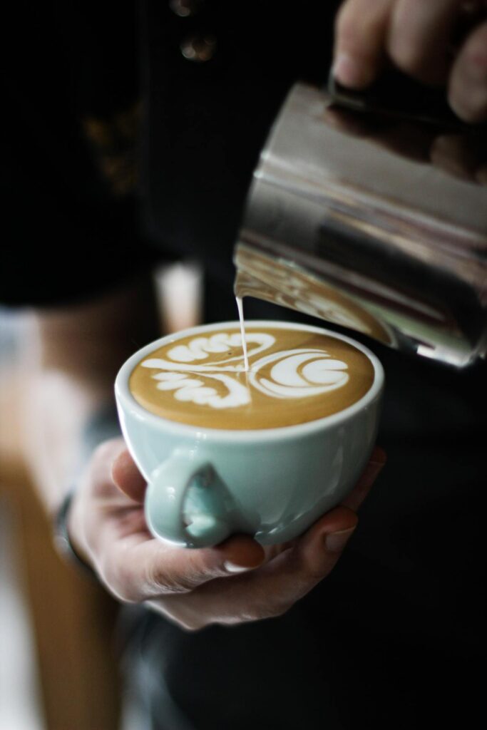 An artisanal coffee shop with a barista expertly pouring latte art,