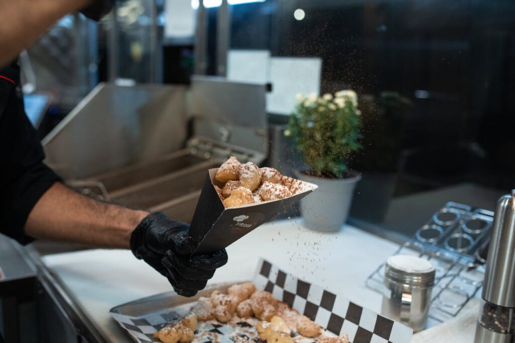 Sprinkling of Cocoa Powder on Beignet Fritters