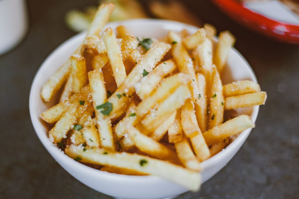 Bowl of fries tossed with cornstarch and seasoning.