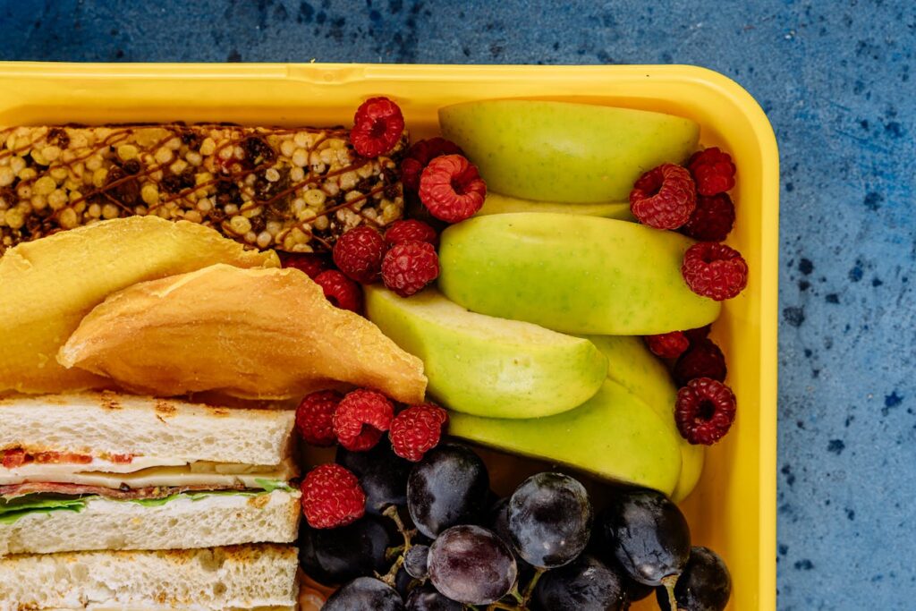 School lunchbox with freeze-dried fruit crisps next to a sandwich.