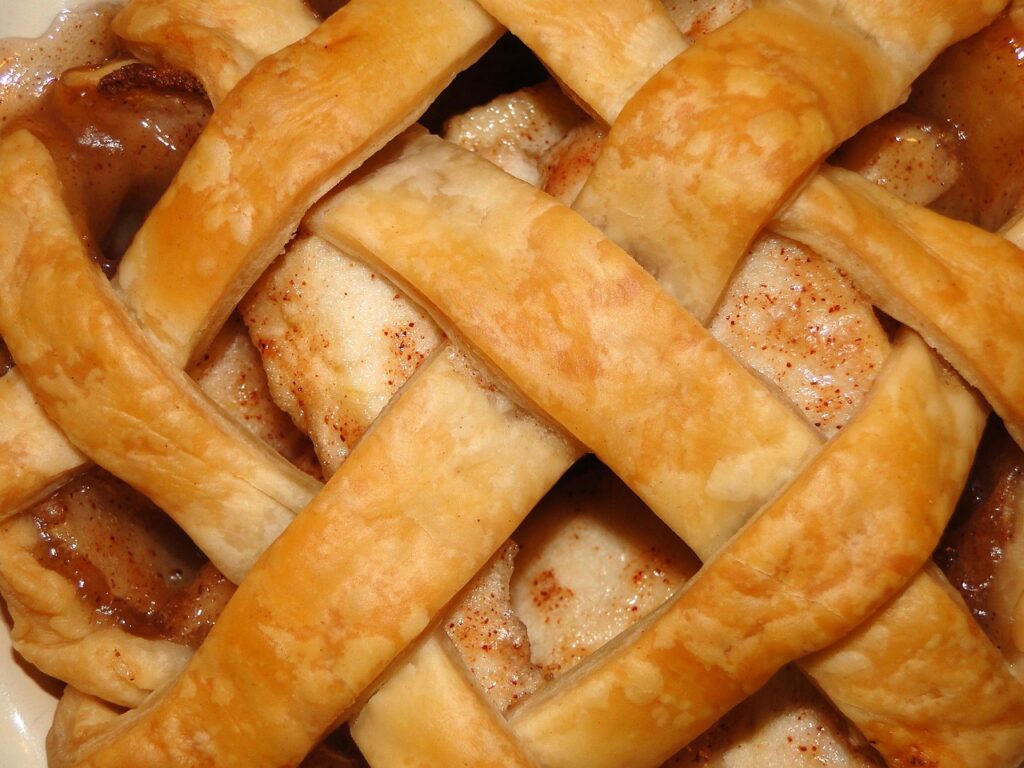 A golden pot pie with flaky crust and steam rising.