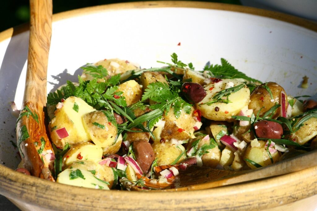 Salad with warm roasted vegetables on top of fresh greens.