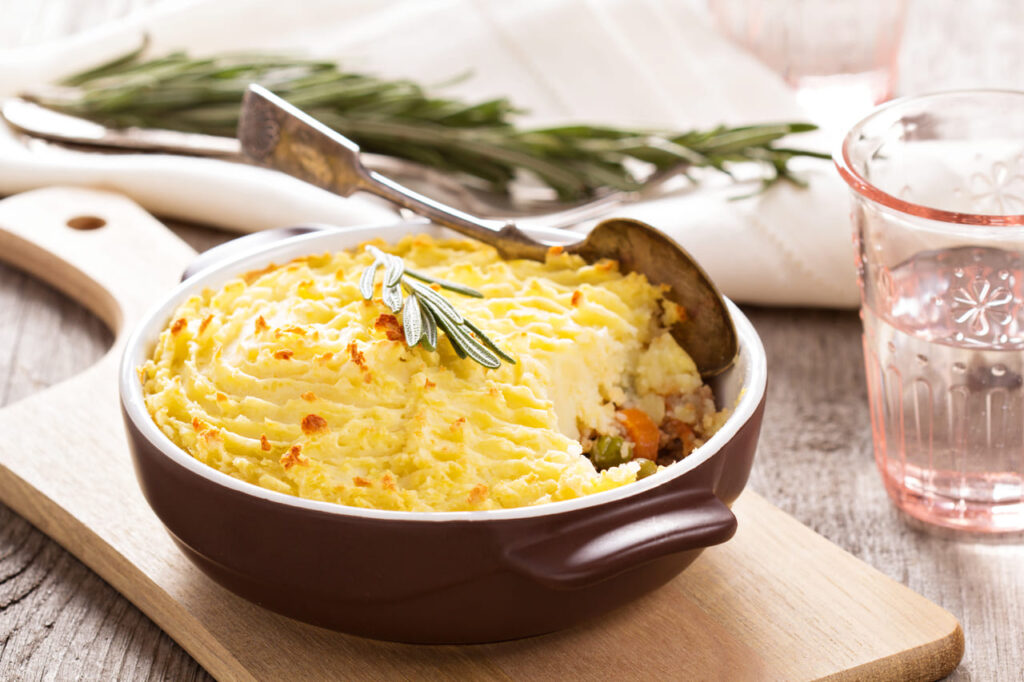 Individual ramekin of shepherd’s pie with bubbling edges.