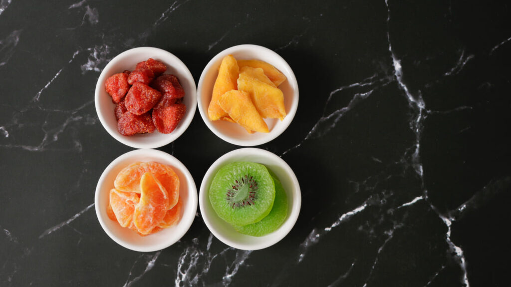 Close-up of freeze-dried strawberries and mango slices in a bowl.
