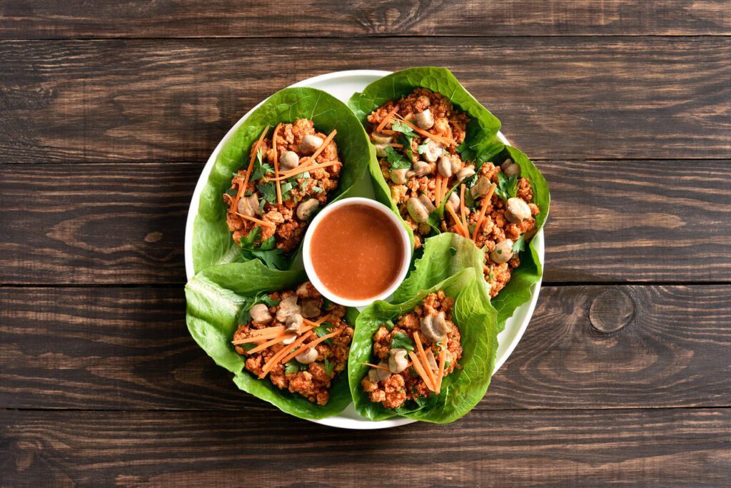 Lettuce wraps on a rustic wooden table.