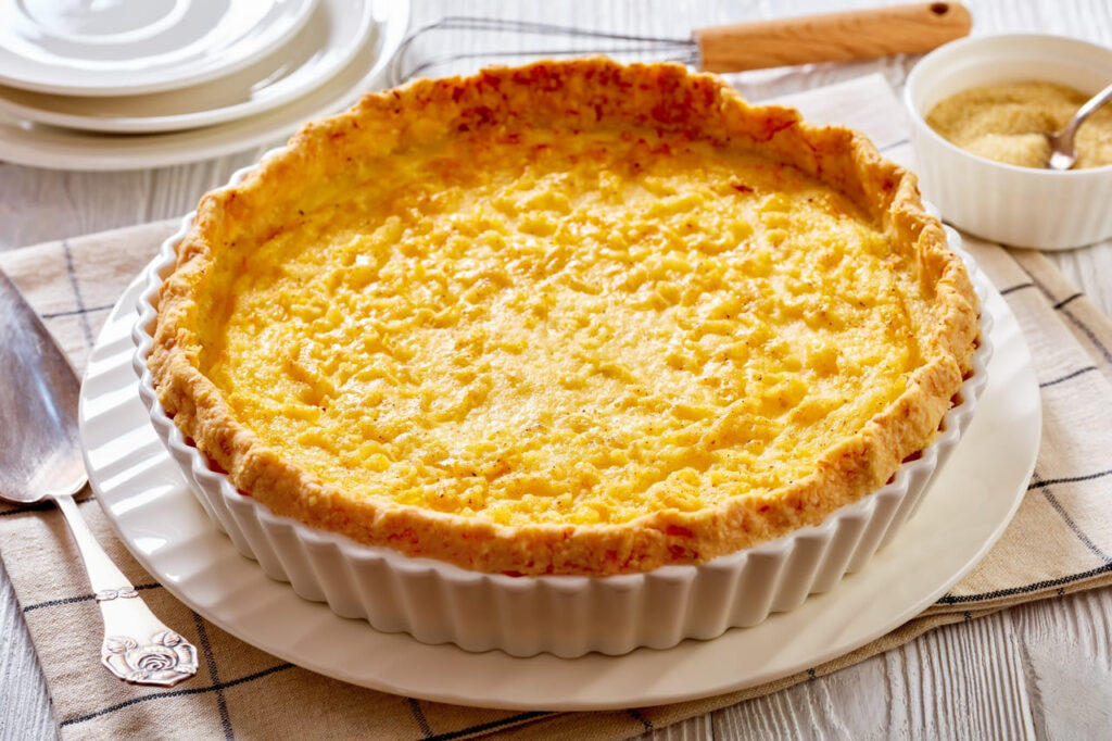 close-up of Classic chess pie pairs a traditional butter pie crust with a sweet, custardy filling in white baking dish, american cuisine, horizontal view from above