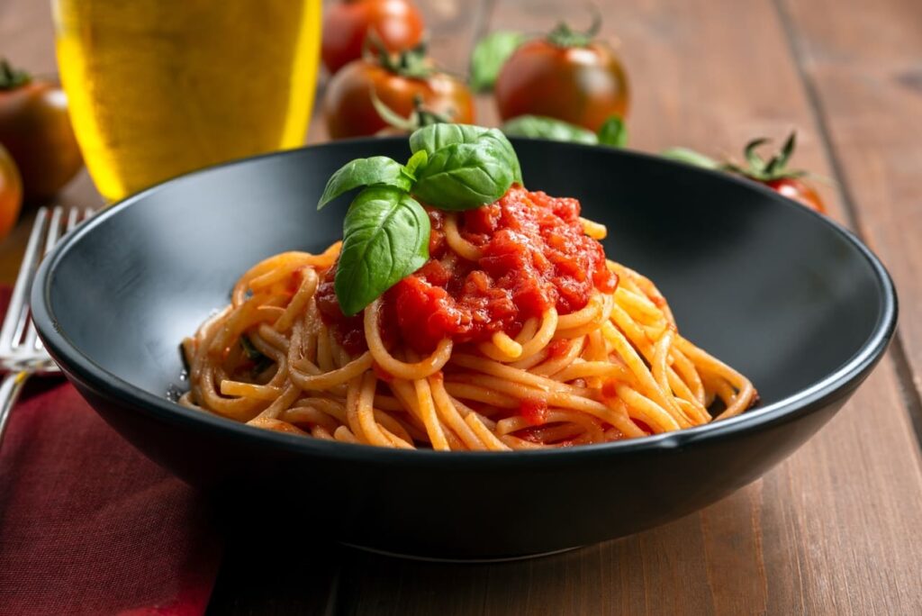 Pomodoro: Fresh tomatoes, basil, and a pot of simmering sauce.