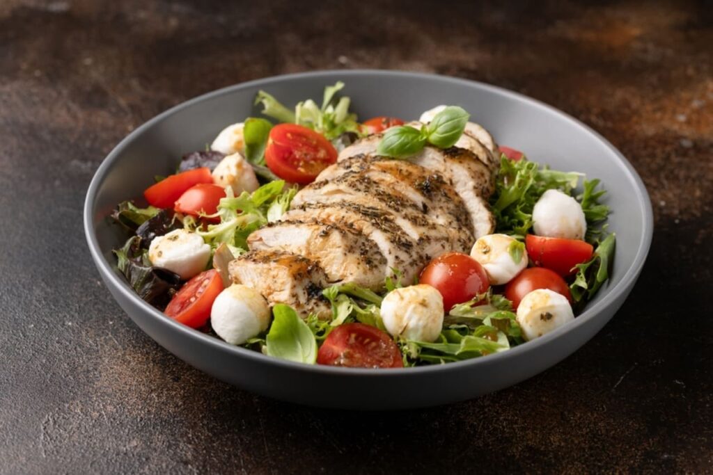 Chicken caprese salad with tomato, mozzarella and balsamic dressing