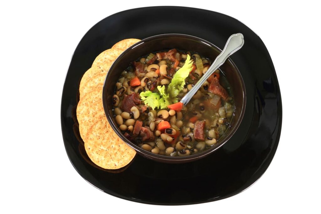 Black-eyed peas with smoked ham in a rustic bowl.