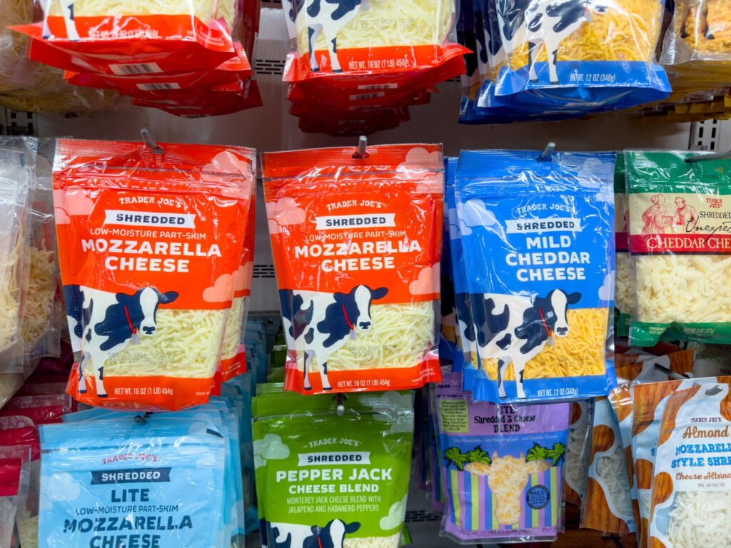 A view of several packages of Trader Joe's shredded cheese.