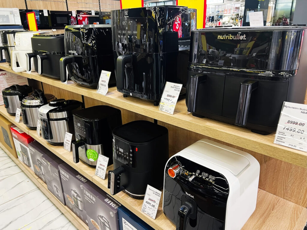Row of budget-friendly air fryers in store display