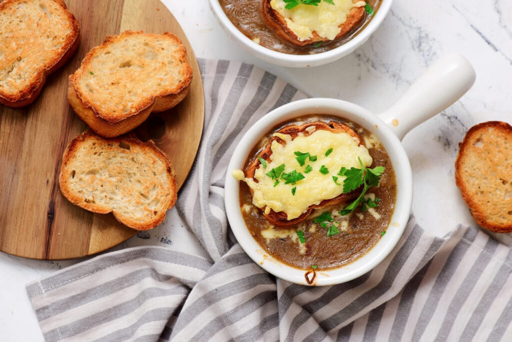 Crock of French onion soup topped with melted cheese and crusty bread.