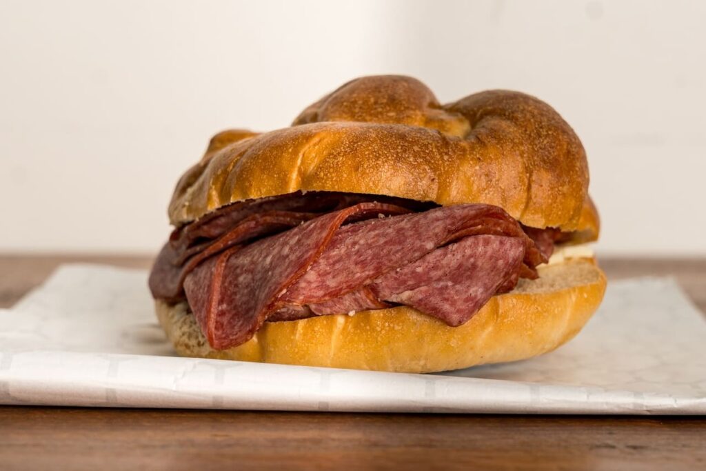 Lebanon bologna and cheese on a pretzel roll