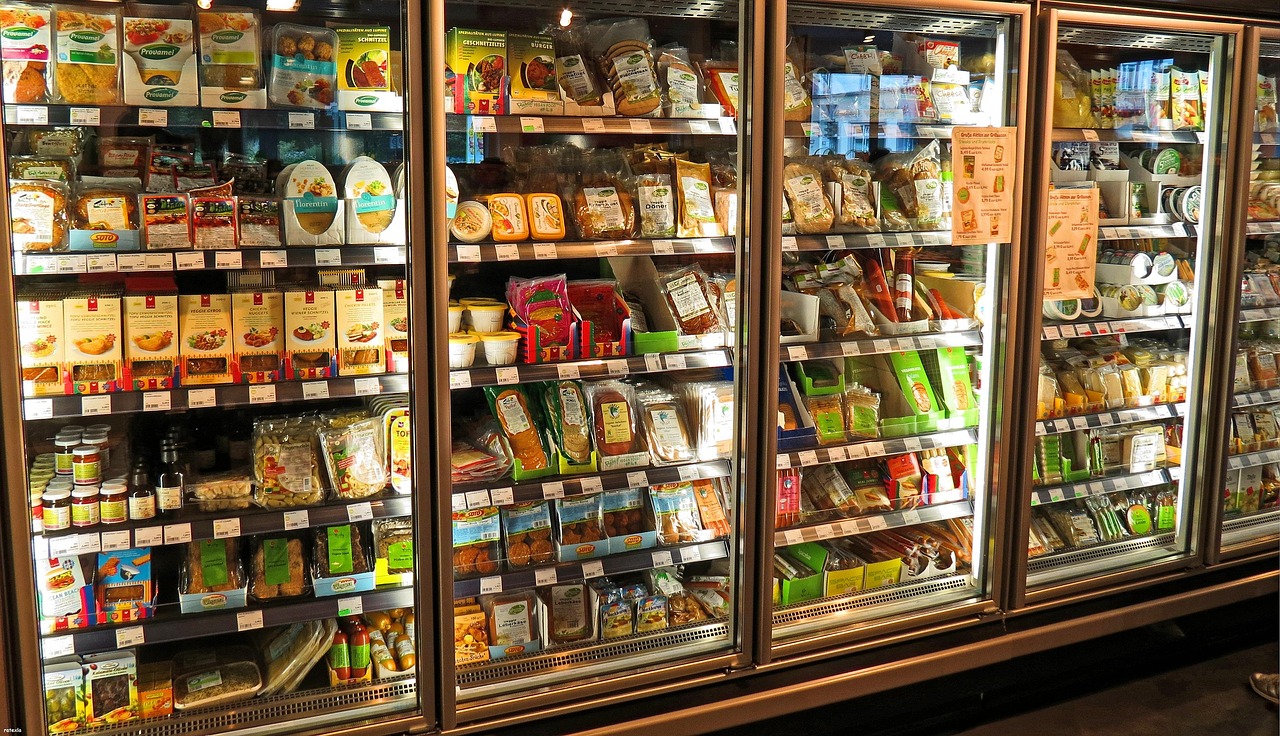 Costco fridge aisle with fresh food items in view